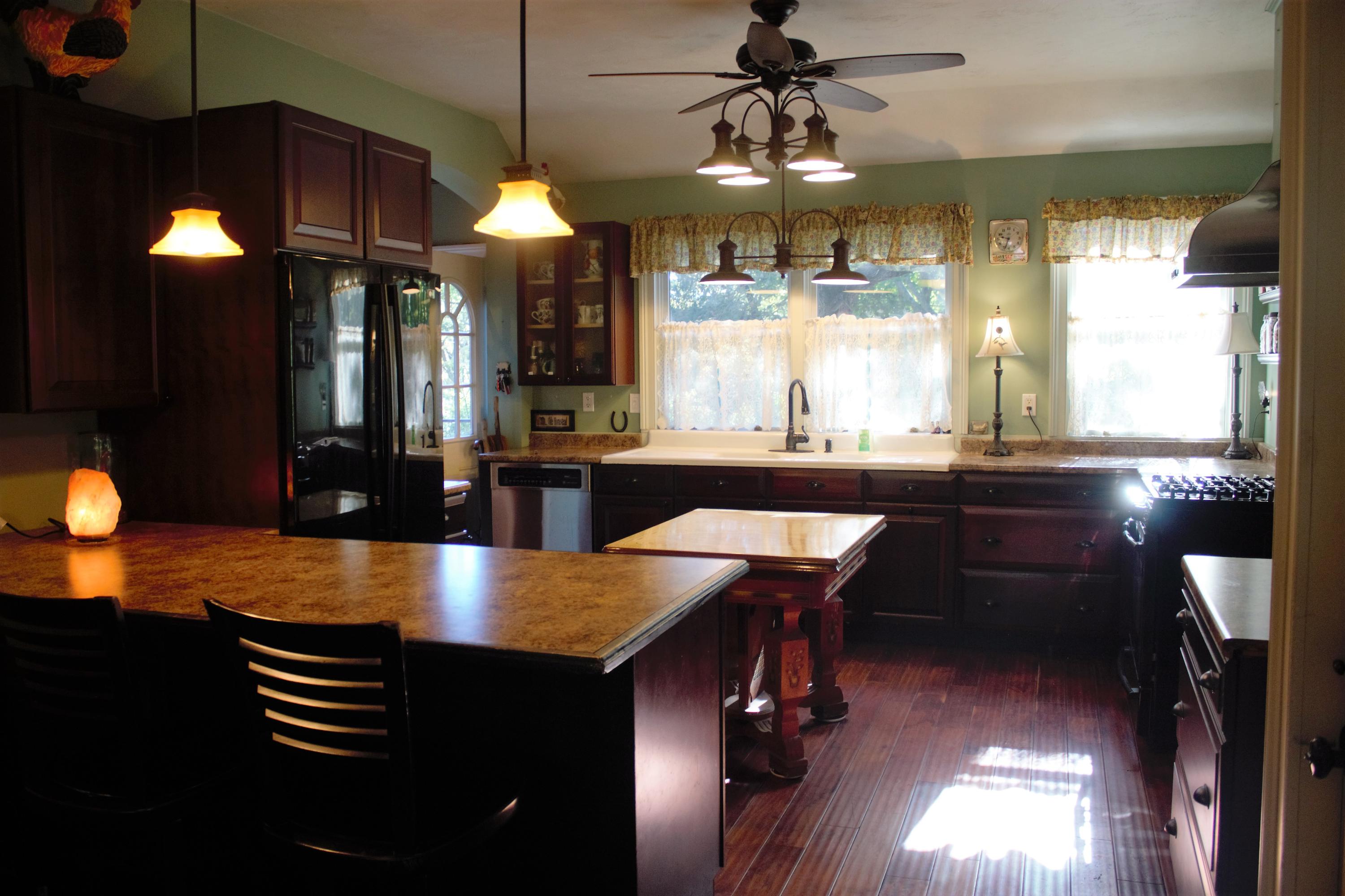 520 Main Street Wareham, MA 02571 - Photo 6 of 32 a kitchen with stainless steel appliances granite countertop a sink a stove and a wooden floors