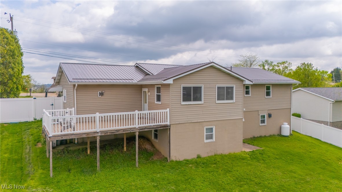 53350 High Ridge Road Bridgeport, OH 43912 - Photo 3 of 37 Back of house featuring a lawn, a deck, and metal roof