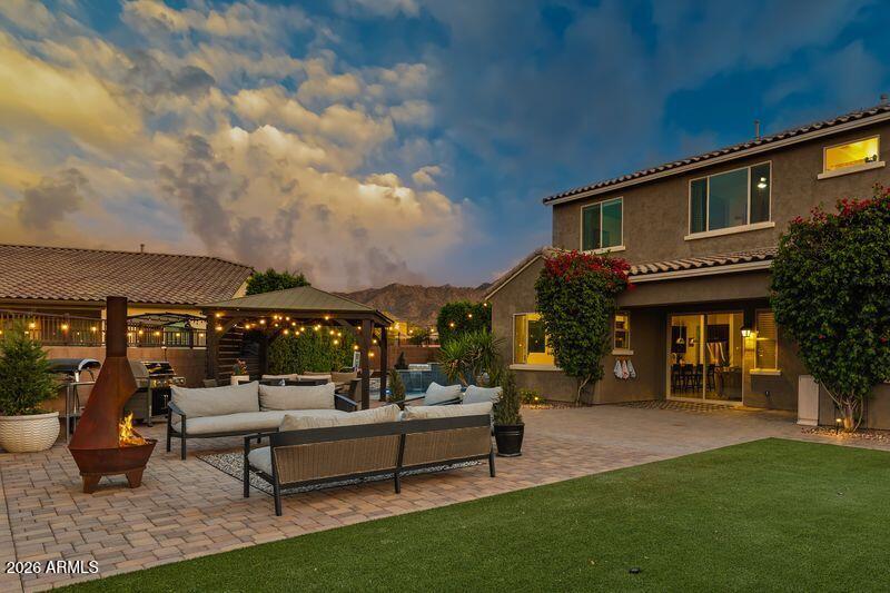 7871 South Stuart Avenue Gilbert, AZ 85298 - Photo 55 of 77 a view of a patio with couches and table and chairs and potted plants