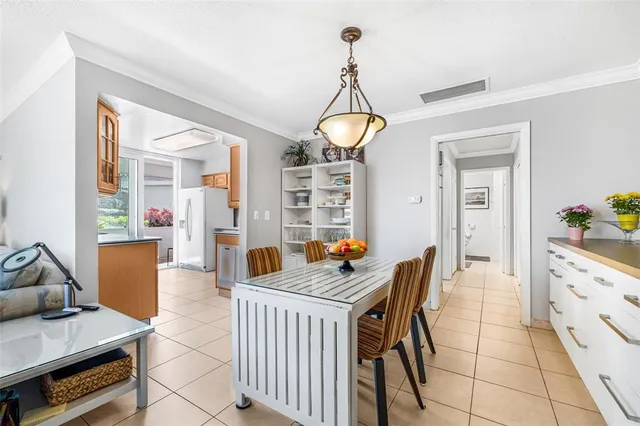 a dining room with furniture a chandelier and wooden floor