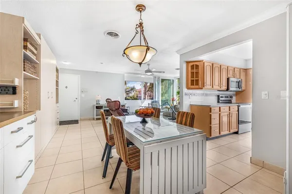 a kitchen with stainless steel appliances granite countertop a stove top oven a sink dishwasher and white cabinets with wooden floor