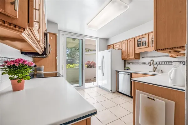 a kitchen with a refrigerator and a sink