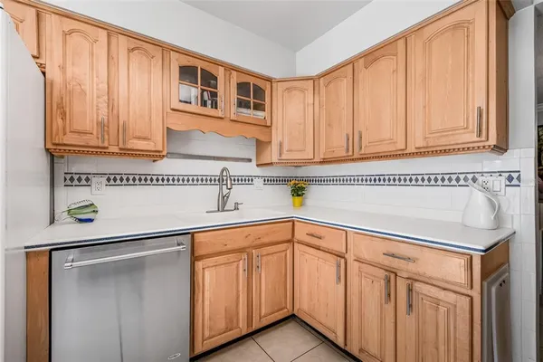 a kitchen with stainless steel appliances granite countertop a sink and dishwasher with cabinets