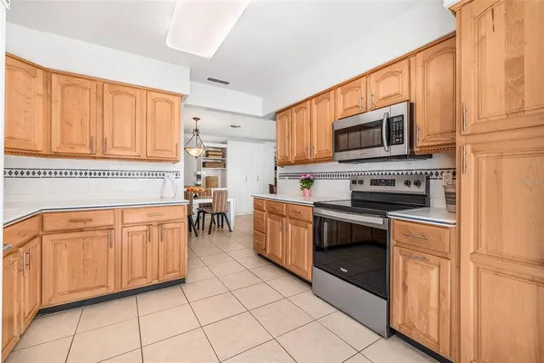 a kitchen with stainless steel appliances granite countertop a refrigerator and microwave