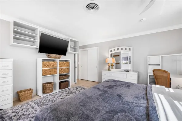 a bedroom with a bed and a television