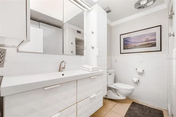 a bathroom with a toilet a sink and mirror