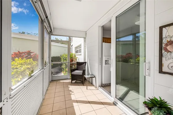 a balcony with couch and glass door