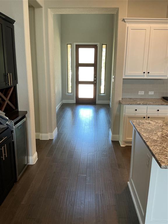 2195 English Ivy Road Frisco, TX 75033 - Photo 3 of 23 View leading to the front door from the kitchen area.....flooring is a such a beautiful enhancement