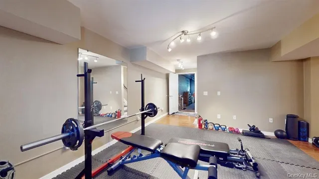 a room with lots of tables a mirror and couch