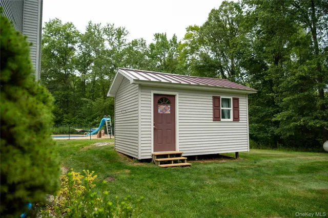 a view of a white house with a yard