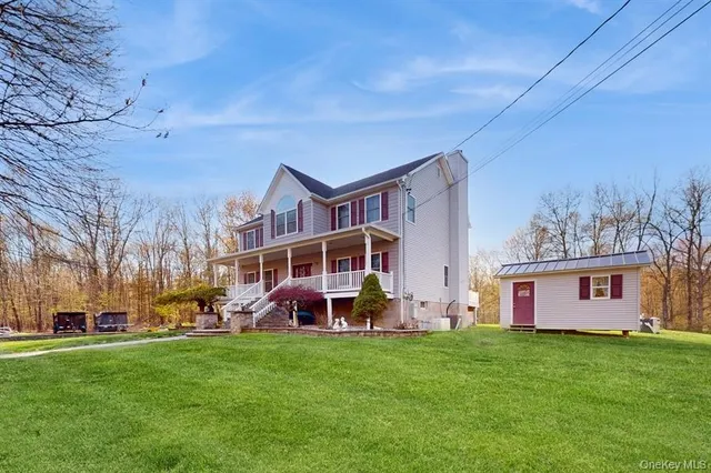 a view of a yard with furniture and garden
