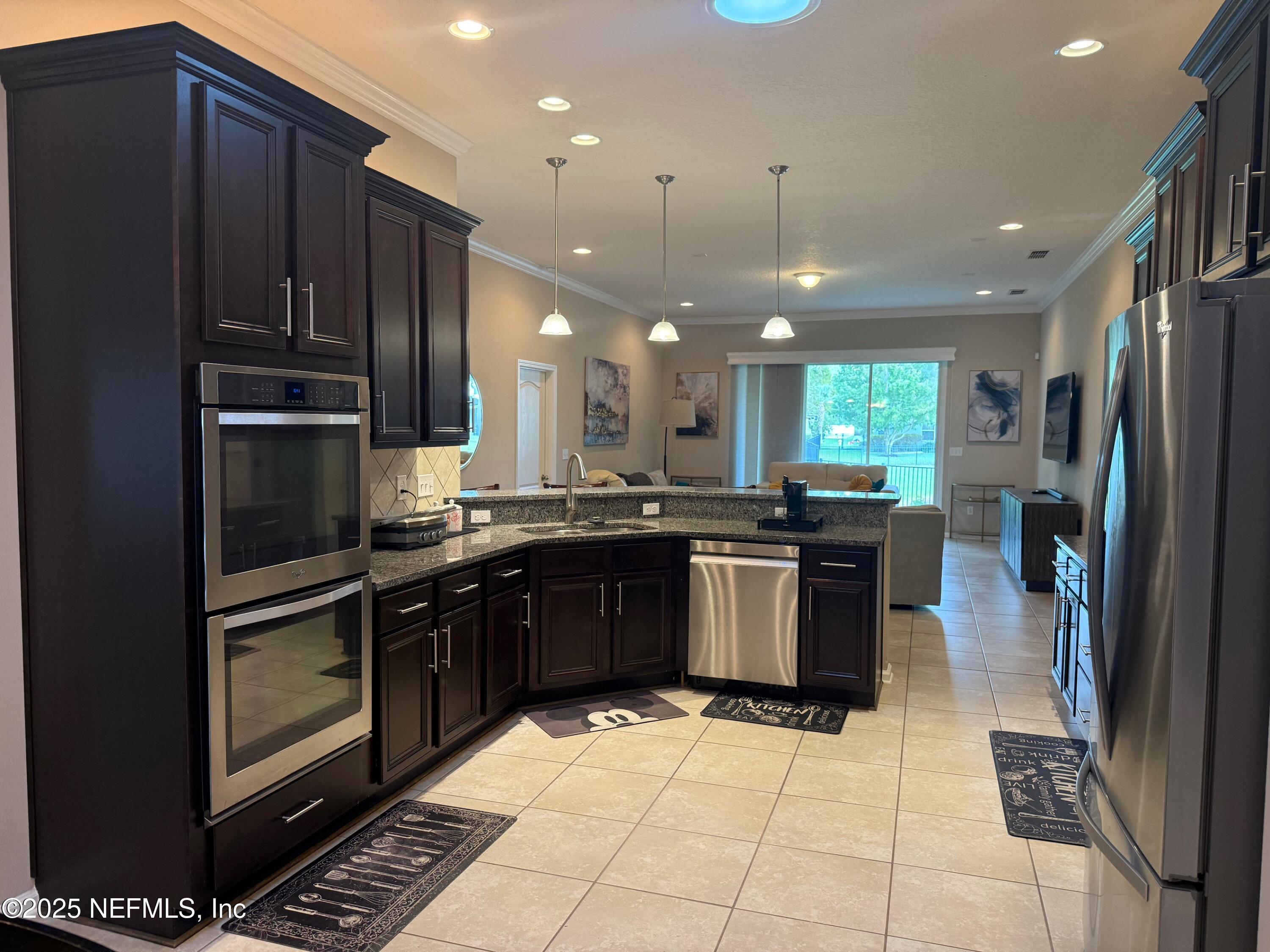 486 Porta Rosa Circle St. Augustine, FL 32092 - Photo 14 of 38 a kitchen with a sink stainless steel appliances and cabinets