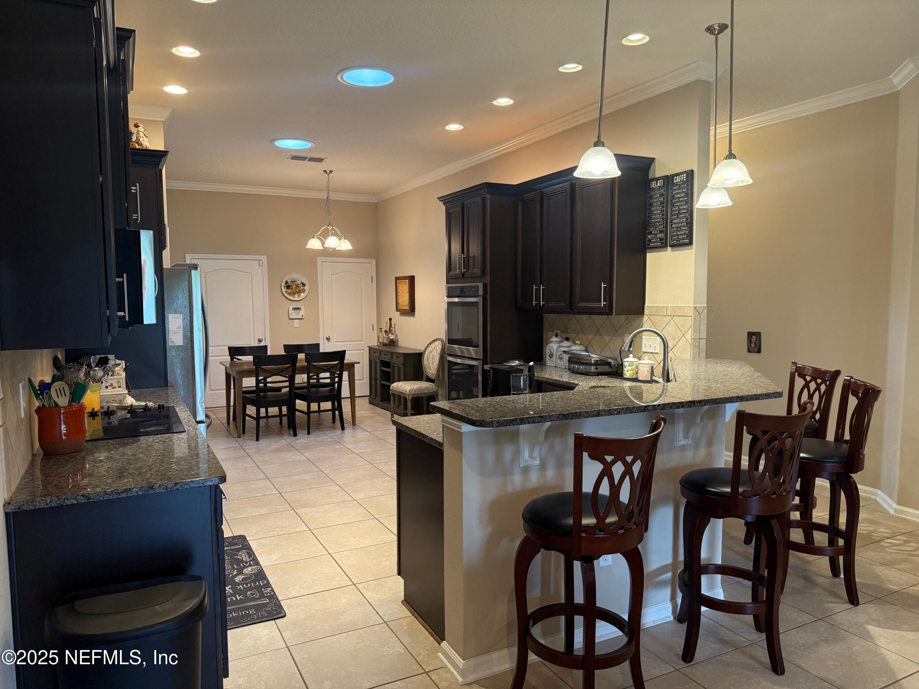486 Porta Rosa Circle St. Augustine, FL 32092 - Photo 15 of 38 a dinning area with furniture and kitchen view