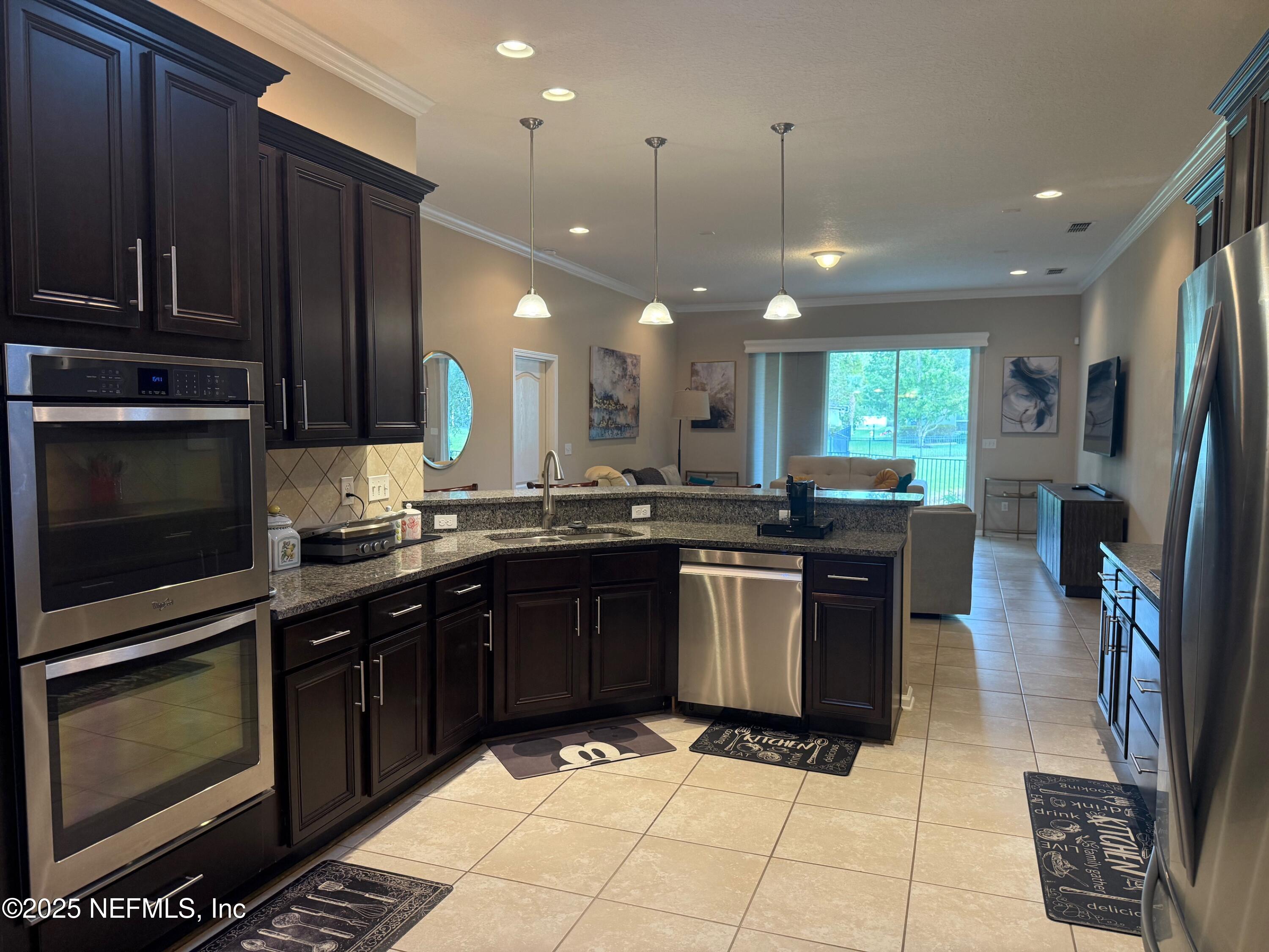 486 Porta Rosa Circle St. Augustine, FL 32092 - Photo 17 of 38 a kitchen with a sink stainless steel appliances and cabinets