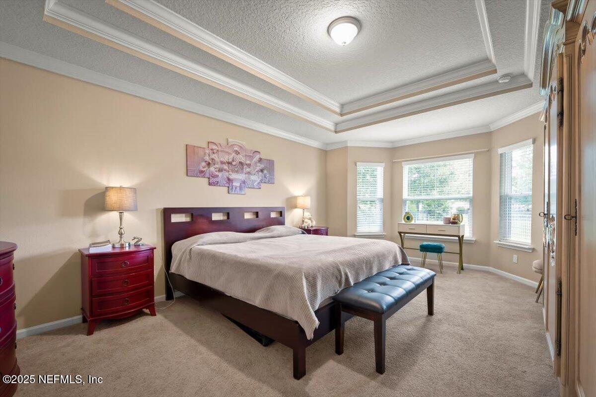 486 Porta Rosa Circle St. Augustine, FL 32092 - Photo 21 of 38 a bedroom with a large bed and a large window