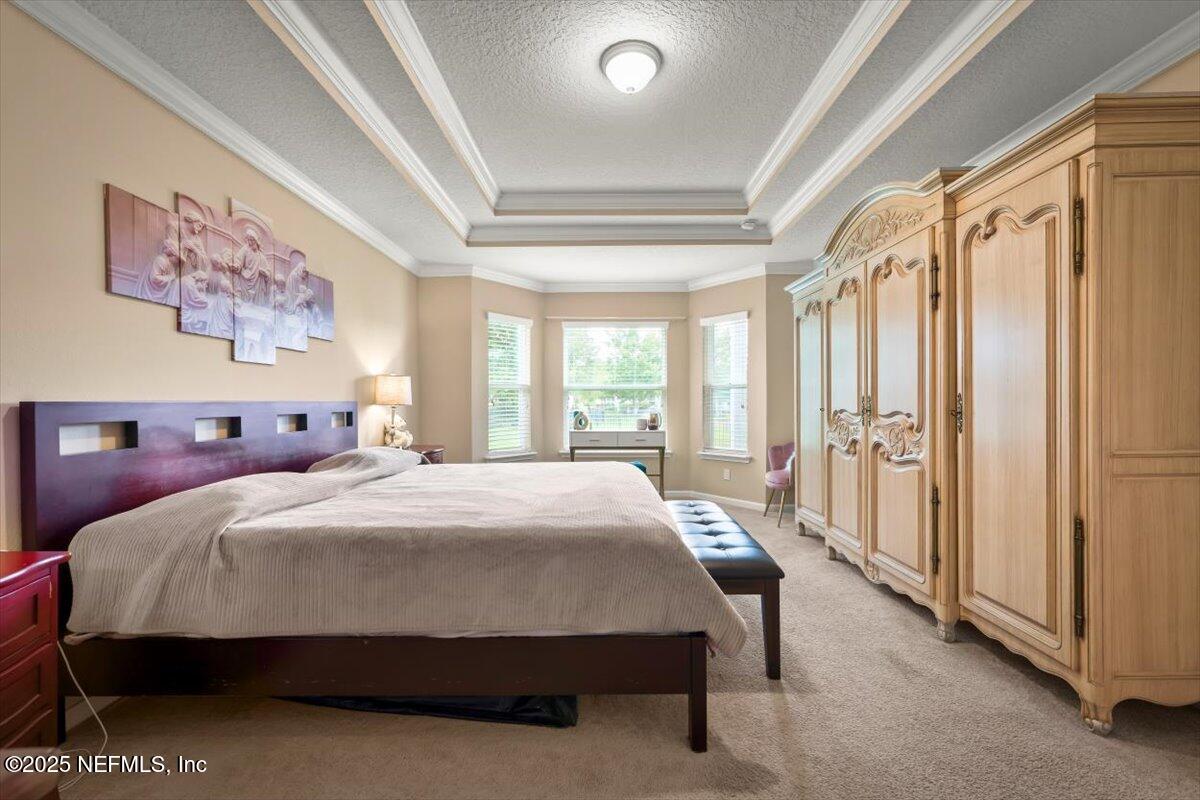 486 Porta Rosa Circle St. Augustine, FL 32092 - Photo 23 of 38 a bedroom with a bed and a large window