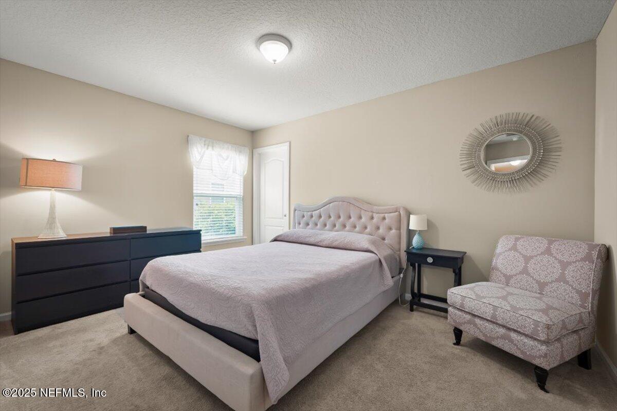 486 Porta Rosa Circle St. Augustine, FL 32092 - Photo 26 of 38 a bedroom with bed and a couch