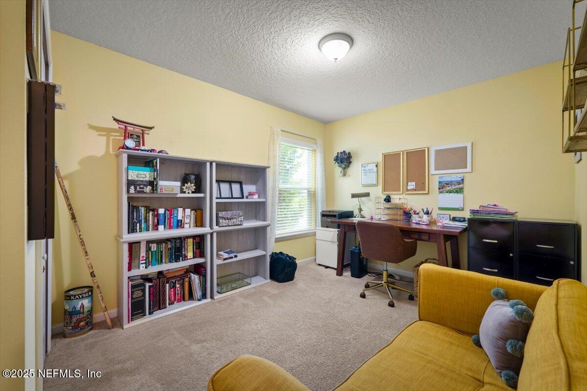 486 Porta Rosa Circle St. Augustine, FL 32092 - Photo 30 of 38 a living room with furniture workspace and a bookshelf