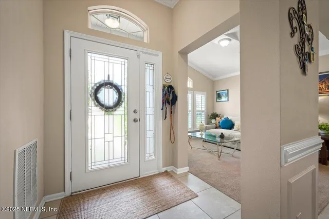 a view of a dining room with furniture a chandelier and a chandelier