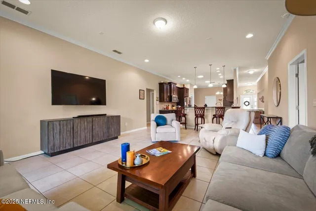 a view of a dining room with furniture and chandelier