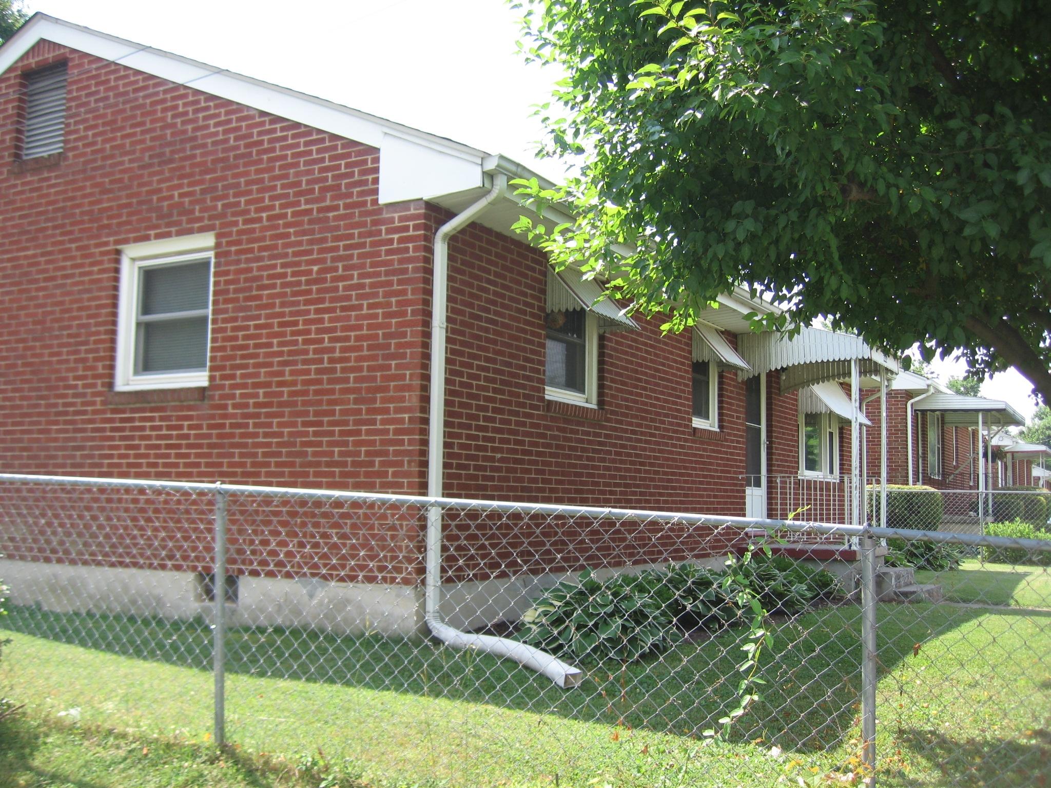 222 Ross Street Salem, VA 24153 - Photo 2 of 17 a brick house with a yard and plants
