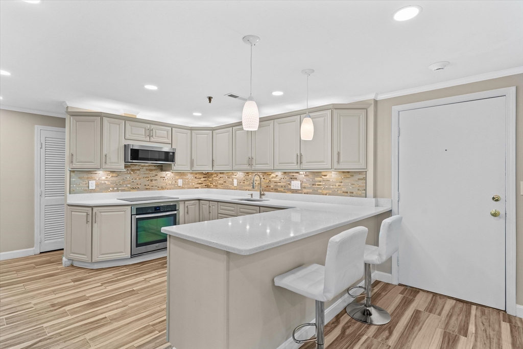 45 Christopher Drive, Unit 93 Methuen, MA 01844 - Photo 1 of 37 a kitchen with stainless steel appliances granite countertop a sink a stove a refrigerator and island with wooden floor