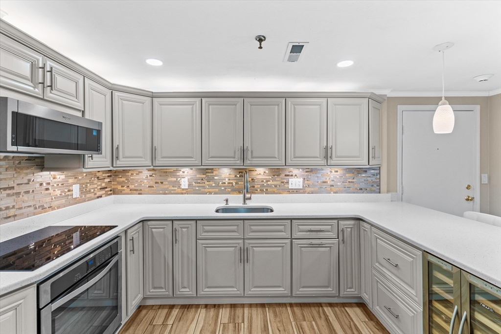 45 Christopher Drive, Unit 93 Methuen, MA 01844 - Photo 13 of 37 a kitchen with a sink stove and cabinets