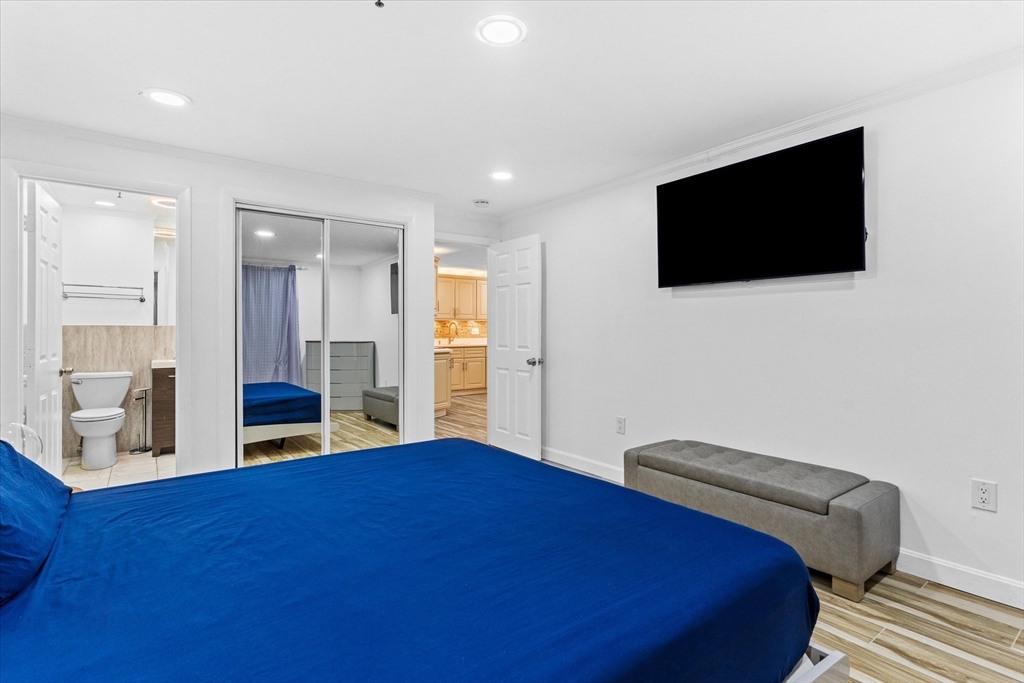 45 Christopher Drive, Unit 93 Methuen, MA 01844 - Photo 19 of 37 a bedroom with a bed and a flat screen tv