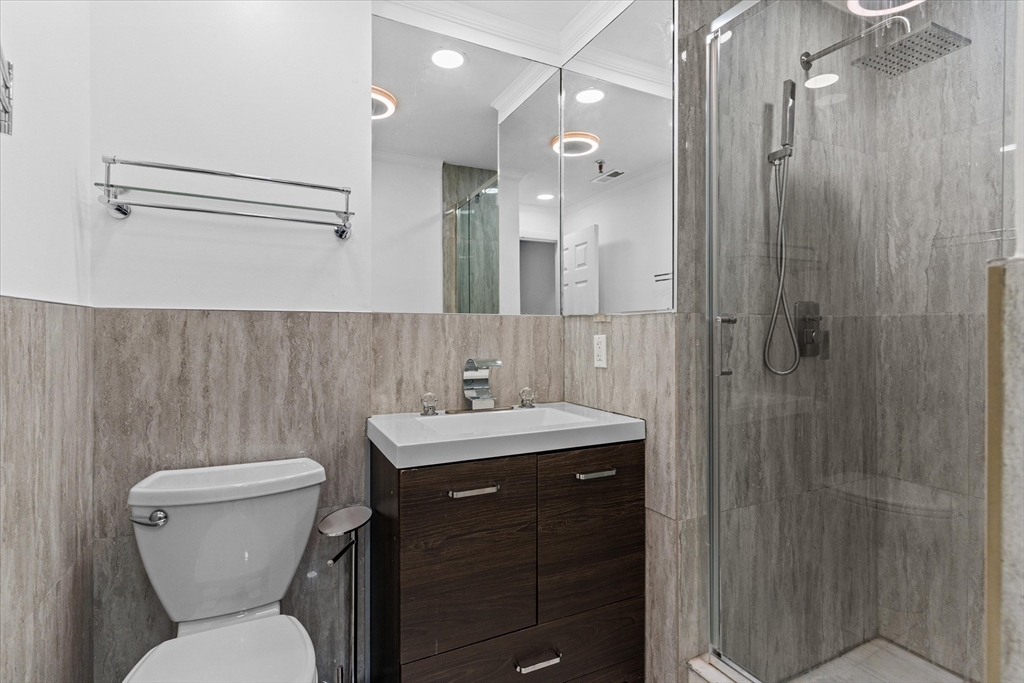 45 Christopher Drive, Unit 93 Methuen, MA 01844 - Photo 20 of 37 a bathroom with a toilet sink shower and mirror