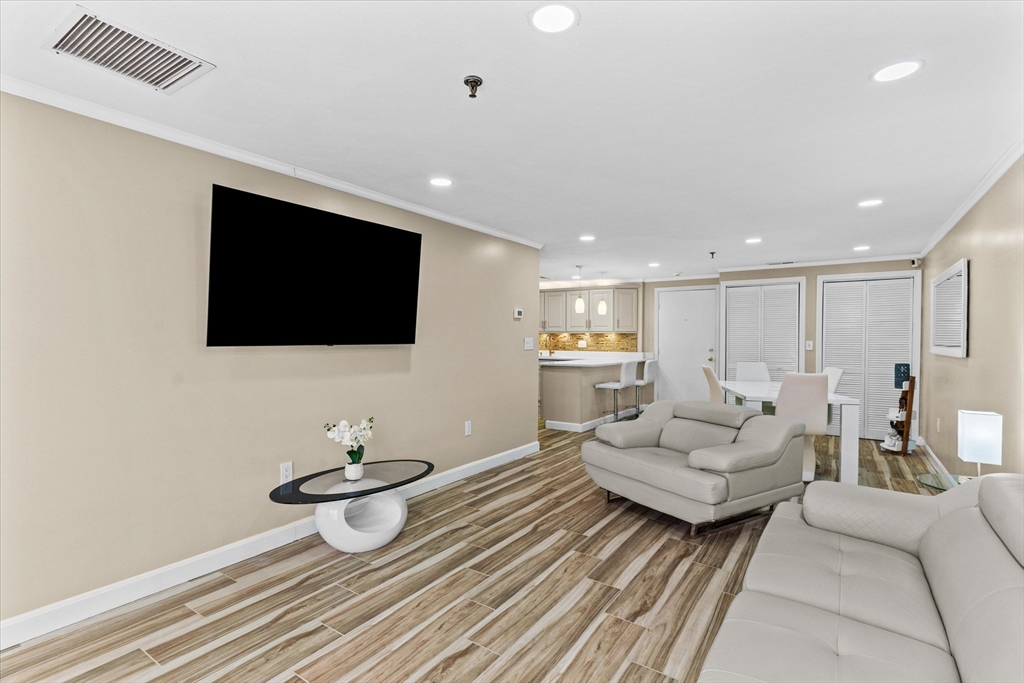 45 Christopher Drive, Unit 93 Methuen, MA 01844 - Photo 9 of 37 a living room with furniture and a flat screen tv