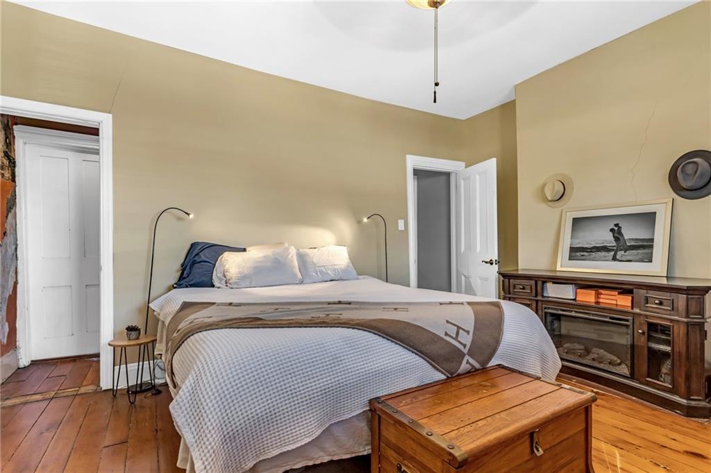 164 37th Street Pittsburgh, PA 15201 - Photo 11 of 24 a bedroom with a bed and wooden floor