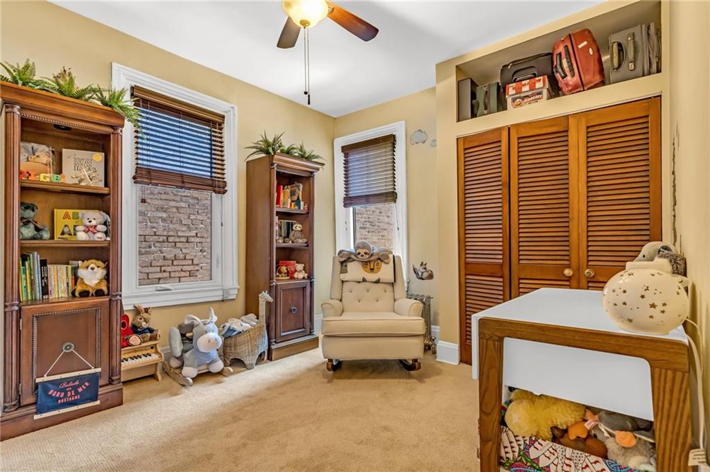 164 37th Street Pittsburgh, PA 15201 - Photo 13 of 24 a living room with furniture and a window