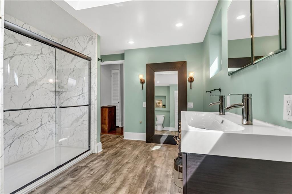 164 37th Street Pittsburgh, PA 15201 - Photo 8 of 24 a large bedroom with a large bed and chandelier