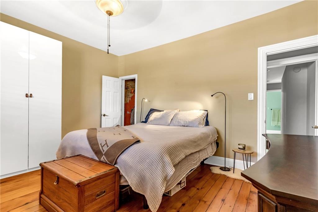 164 37th Street Pittsburgh, PA 15201 - Photo 10 of 24 a bedroom with a bed and a couch