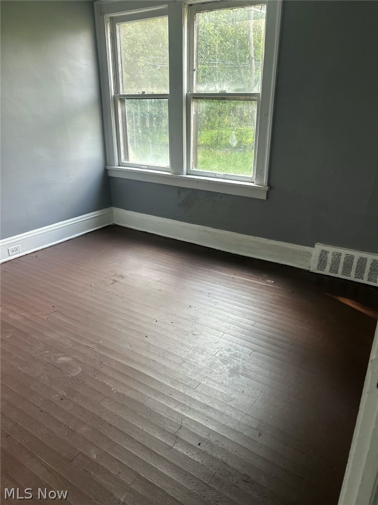1069 Carlyon Road East Cleveland, OH 44112 - Photo 9 of 25 Wood-finish flooring, white window trim, and white baseboards