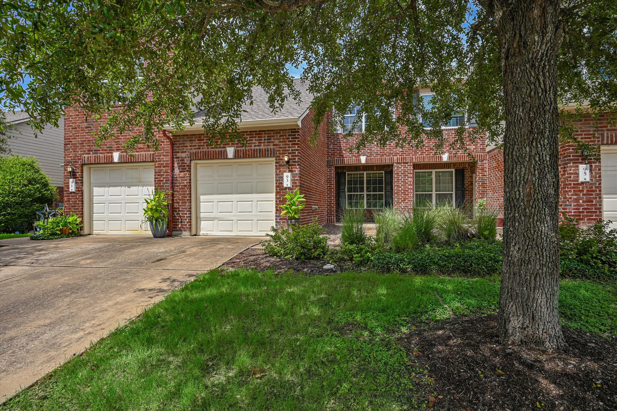 93 Verde Ranch Loop Leander, TX 78641 - Photo 2 of 20 front view of a house with a yard and an trees