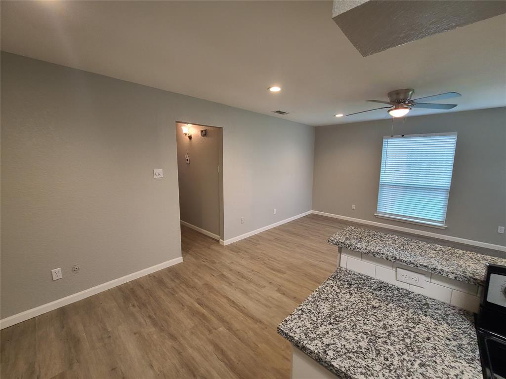 343 Spring Branch Lane Kennedale, TX 76060 - Photo 13 of 39 wooden floor in an empty room with a window