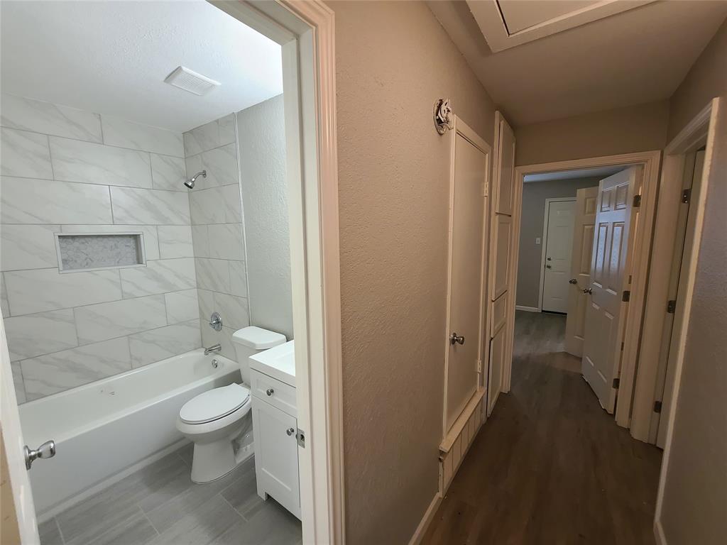 343 Spring Branch Lane Kennedale, TX 76060 - Photo 16 of 39 a bathroom with a granite countertop toilet a sink and shower