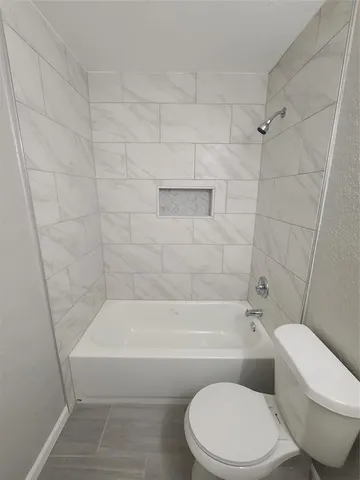 a bathroom with a toilet and bathtub