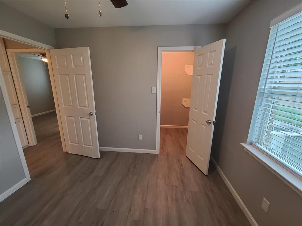 343 Spring Branch Lane Kennedale, TX 76060 - Photo 21 of 39 an empty room with wooden floor and a window