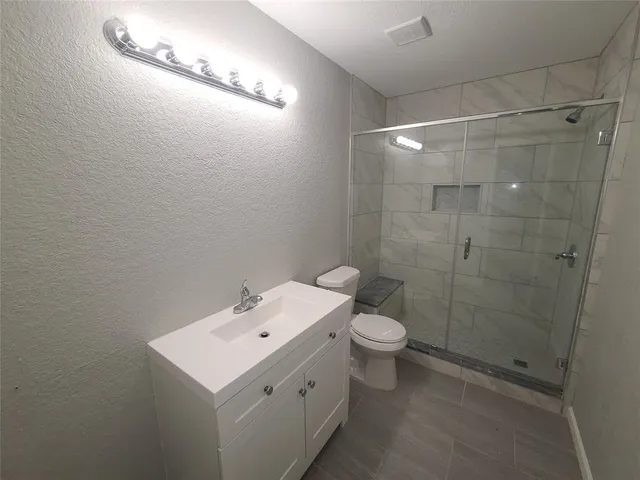 a bathroom with a toilet sink and a shower