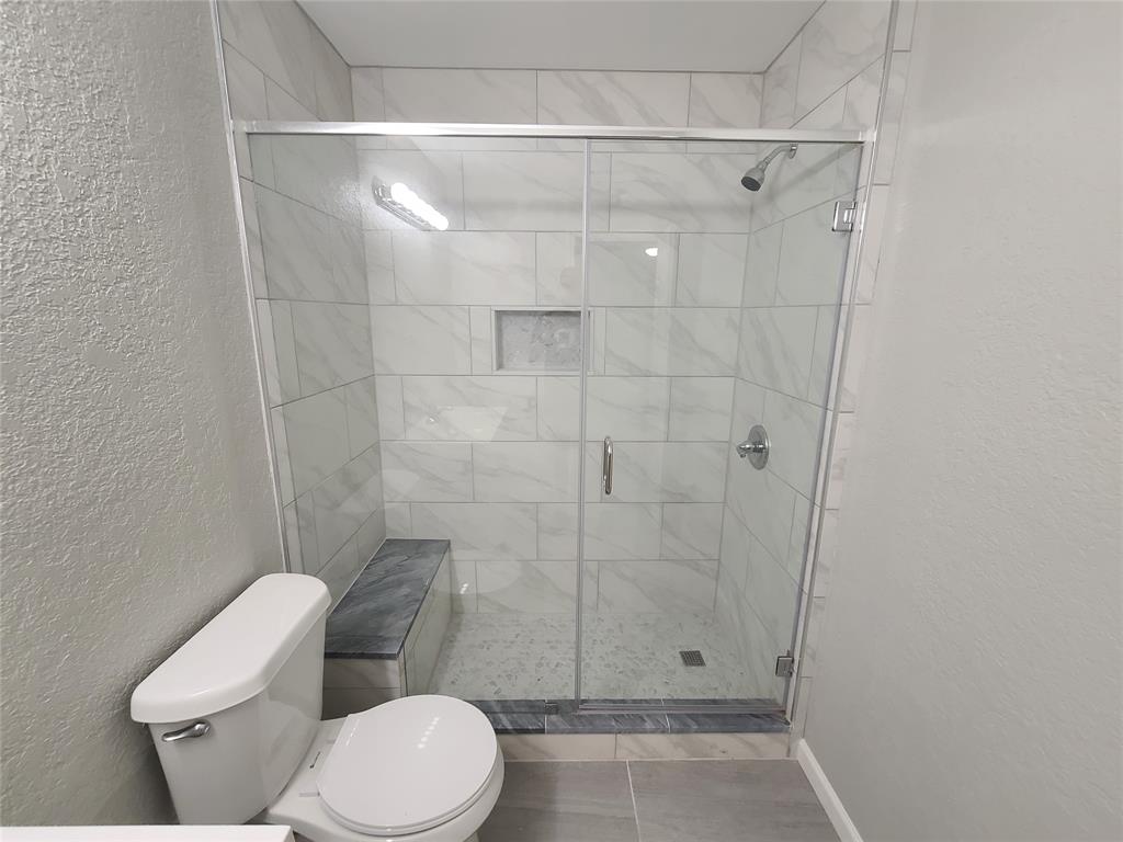 343 Spring Branch Lane Kennedale, TX 76060 - Photo 30 of 39 a bathroom with a toilet and a shower