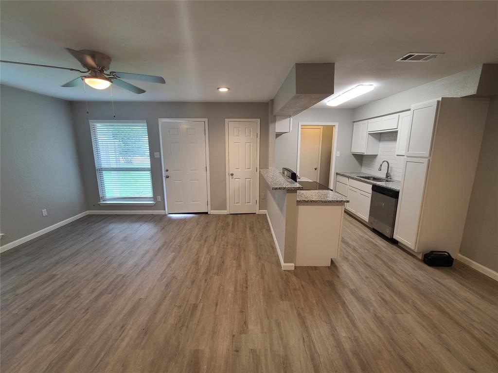 343 Spring Branch Lane Kennedale, TX 76060 - Photo 38 of 39 a view of a kitchen counter space with wooden floor and stainless steel appliances