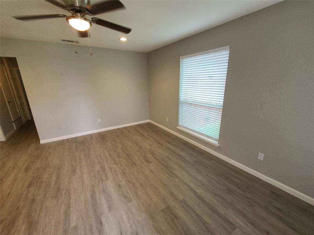 343 Spring Branch Lane Kennedale, TX 76060 - Photo 4 of 39 wooden floor in an empty room with a window
