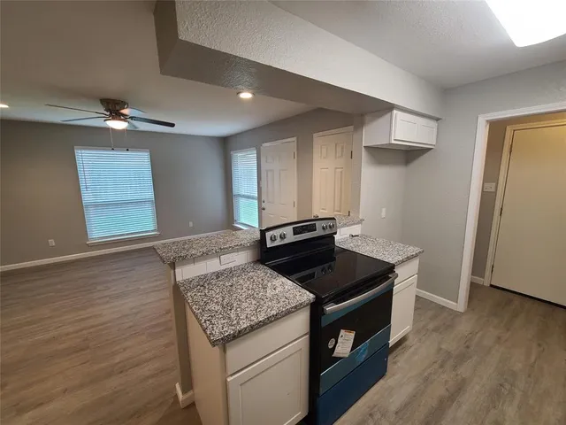 a kitchen that has a sink and a stove in it