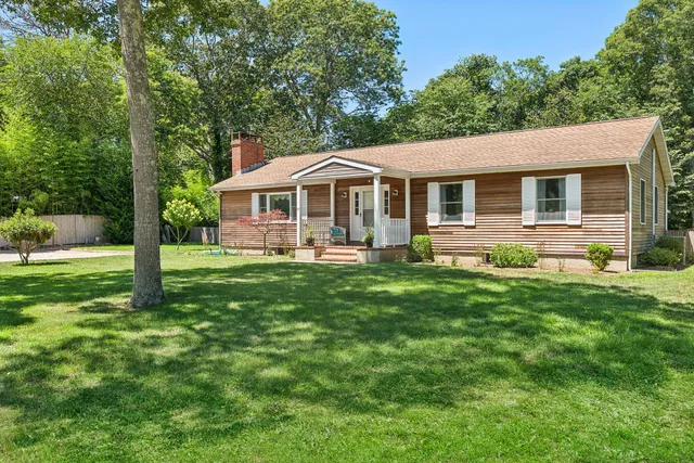 a front view of house with yard and green space
