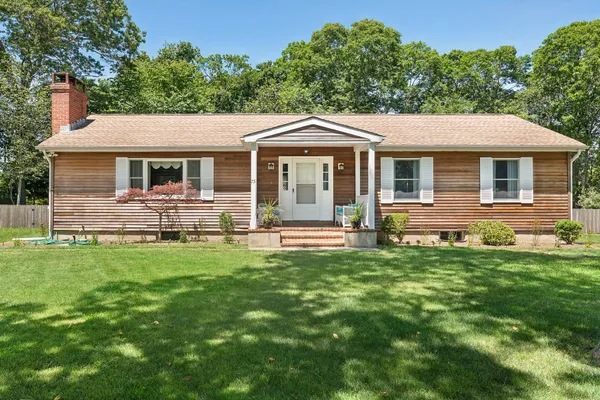 a front view of house with yard and green space
