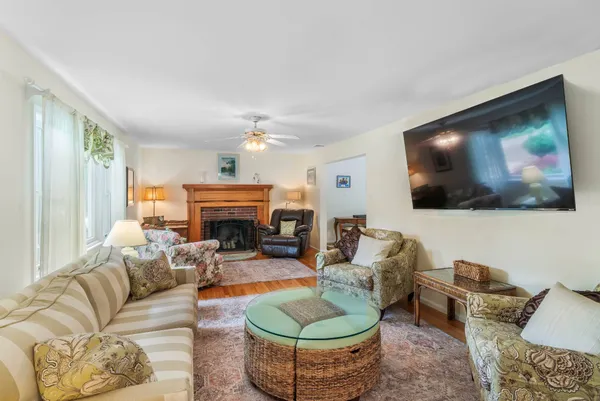 a living room with furniture a flat screen tv and a fireplace
