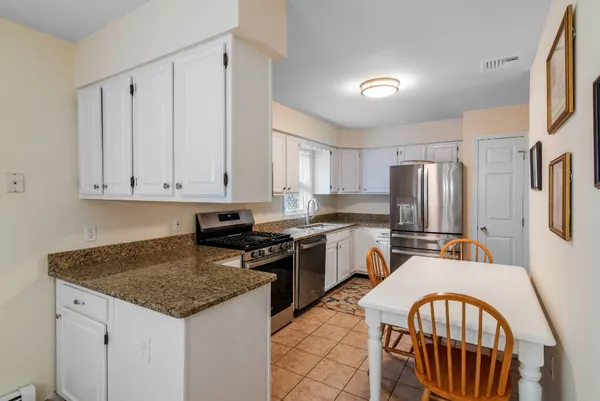 a kitchen with stainless steel appliances granite countertop a stove a sink dishwasher a refrigerator and cabinets