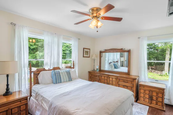 a bedroom with a large bed and a large window